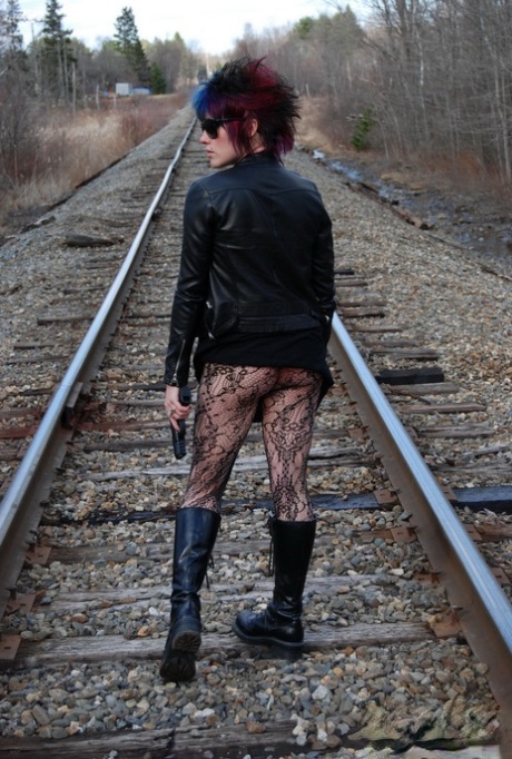Punk girl Sabrina poses for an upskirt solo shoot on railway tracks 60521738