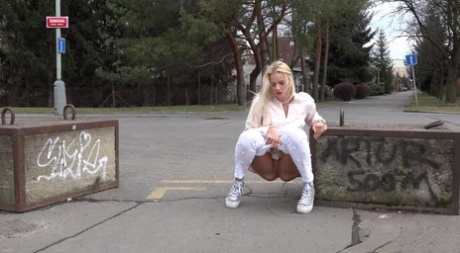 Natural blonde Katy Sky takes a piss on a paved road during the day 87183158