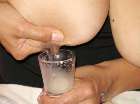 Latina chick fills a shot glass with breast milk before drinking it 44916405