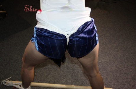 White girl is restrained to a spreader bar while wearing nylon booty shorts 14926418