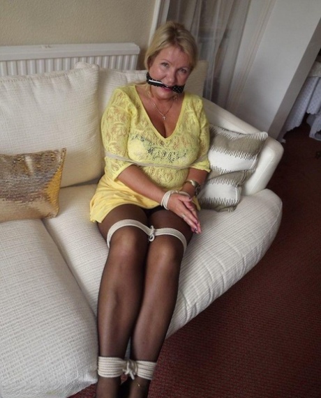 Blonde female is cleaved gagged and tied with rope in a number of dresses 89246871