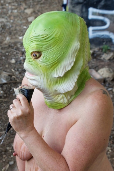 Naked British lady Speedy Bee eats a fish while wearing a costume mask 62075766