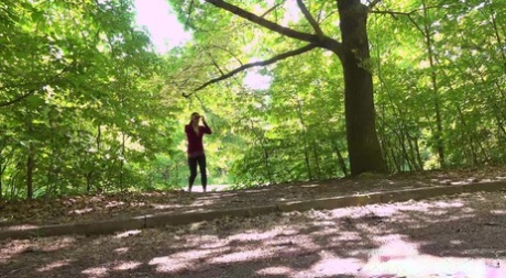 Caucasian woman Valentina Ross takes a big pee next to a tree alongside a road 47220269