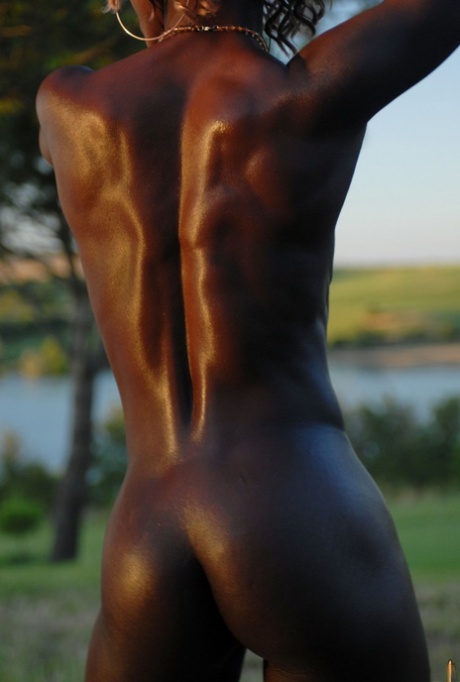 Dark chocolate skinned female shows the pink of her twat during closeup action 68562807