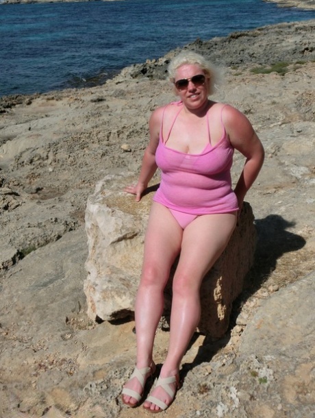 Chubby older blonde Barby gets naked in shades near the ocean 14825086