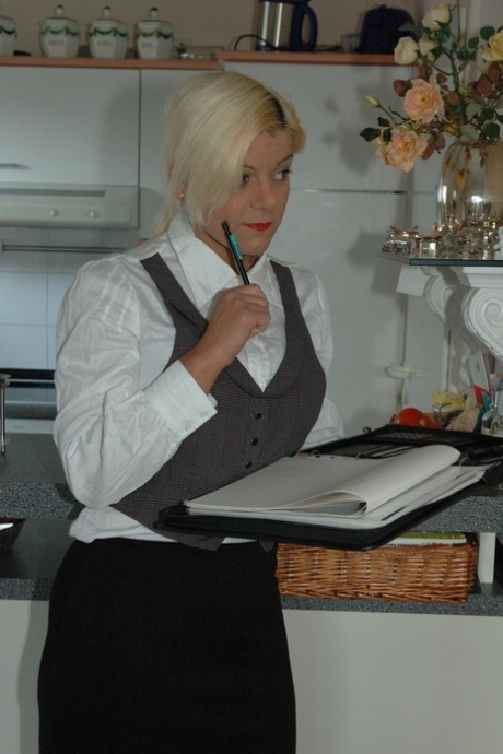 Blonde amateur Martina uncups her big tits before showing her ass in a kitchen 60634049