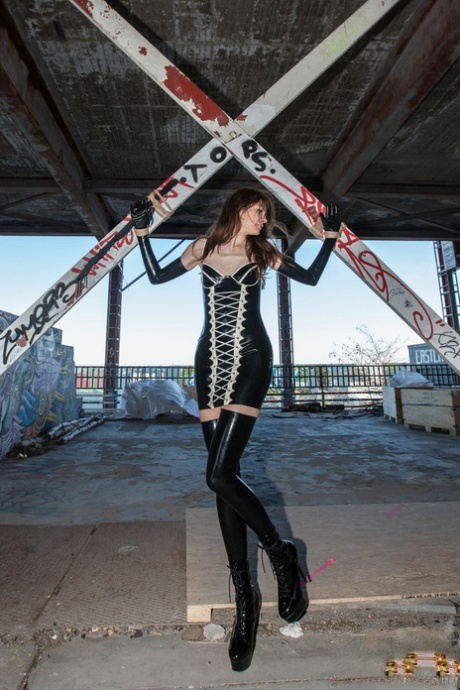 Caucasian female has her arms tied behind her back while modelling in latex 59297254