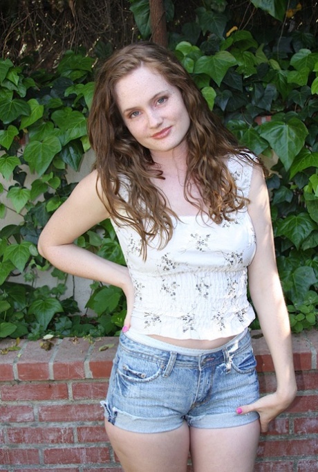 Teen girl with freckles on her face works free of jean shorts for nude poses 63180521